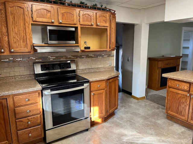 kitchen featuring decorative backsplash, extractor fan, and appliances with stainless steel finishes