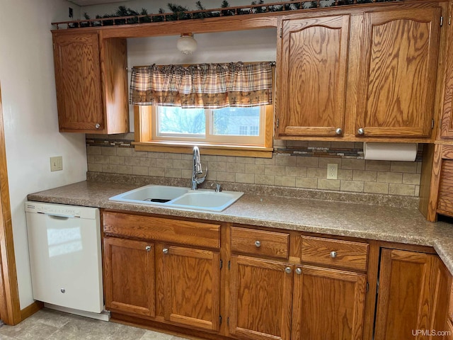 kitchen with backsplash, dishwasher, and sink