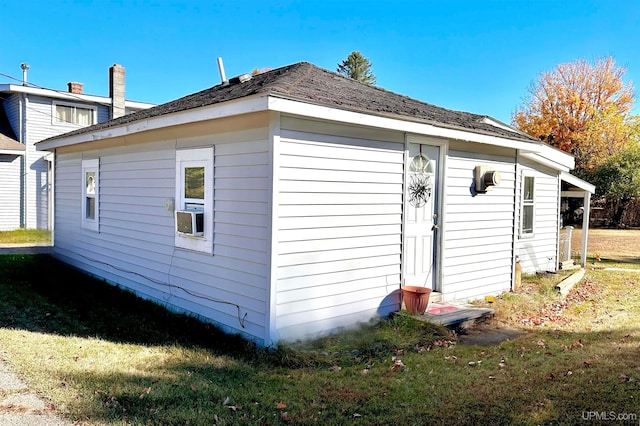 view of side of property with a lawn