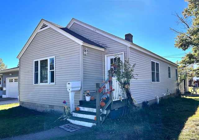 view of front of property with a garage and a front lawn