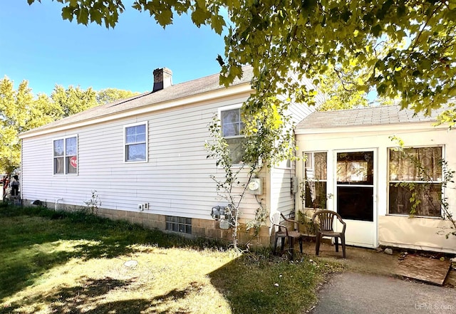 rear view of property featuring a yard