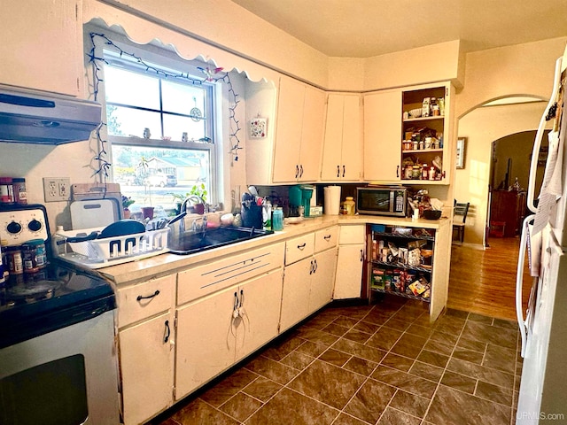 kitchen with white cabinets, sink, and dark hardwood / wood-style flooring