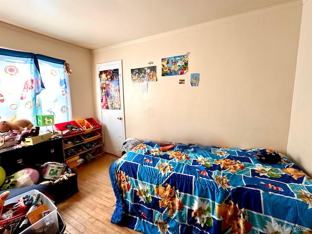 bedroom featuring hardwood / wood-style flooring and crown molding