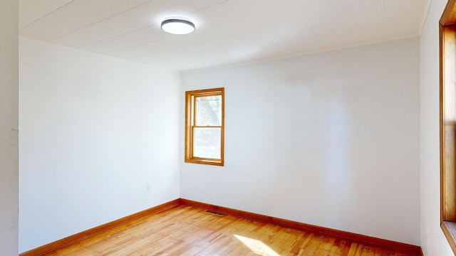 empty room with hardwood / wood-style flooring