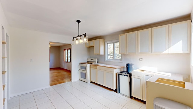 kitchen with refrigerator, pendant lighting, a notable chandelier, light hardwood / wood-style flooring, and white range