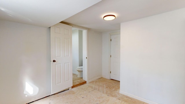 interior space featuring connected bathroom and hardwood / wood-style floors