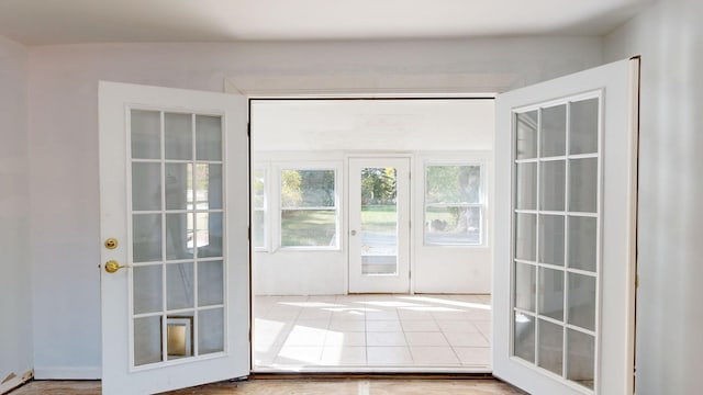 doorway with wood-type flooring and french doors