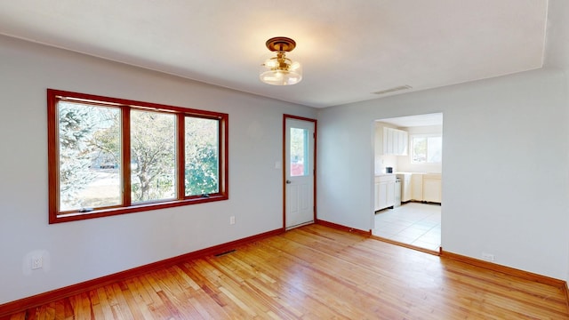 spare room with light hardwood / wood-style floors