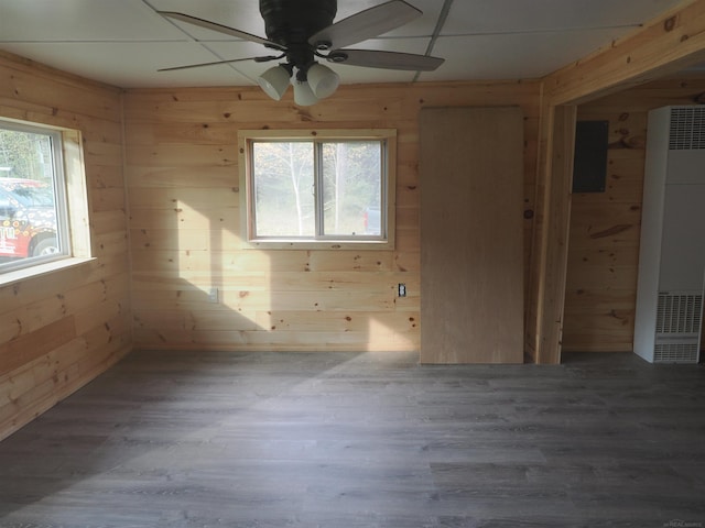 spare room featuring hardwood / wood-style flooring, a wealth of natural light, and wood walls