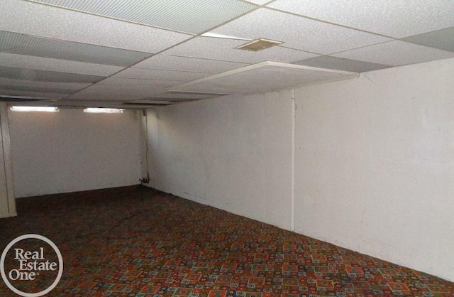 basement featuring a paneled ceiling