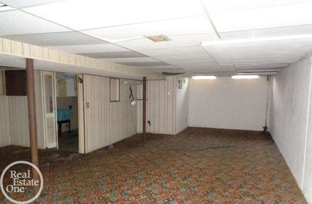 basement featuring a paneled ceiling