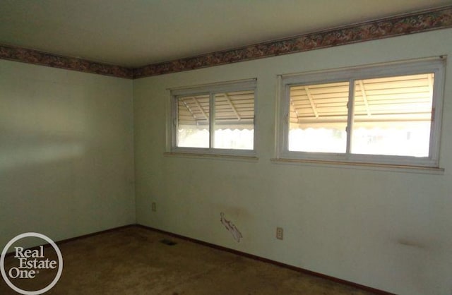 empty room featuring carpet floors and a wealth of natural light