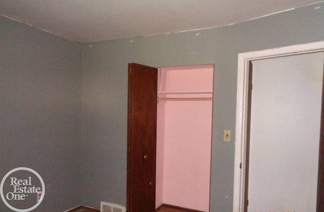 unfurnished bedroom with a closet