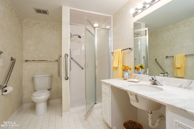 bathroom with tile patterned flooring, an enclosed shower, vanity, and toilet