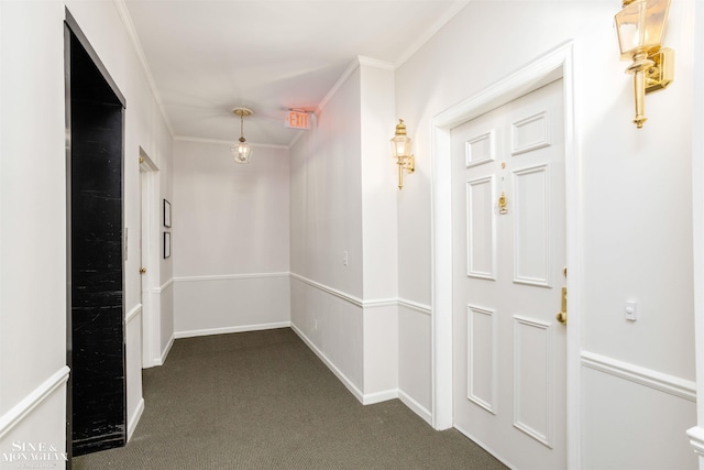 corridor with crown molding and dark carpet