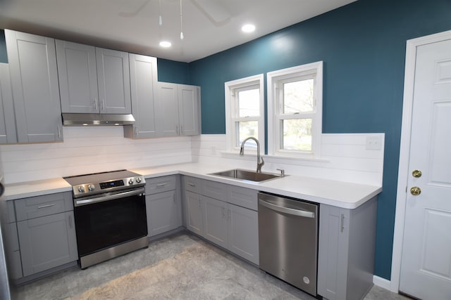 kitchen with gray cabinets, appliances with stainless steel finishes, and sink