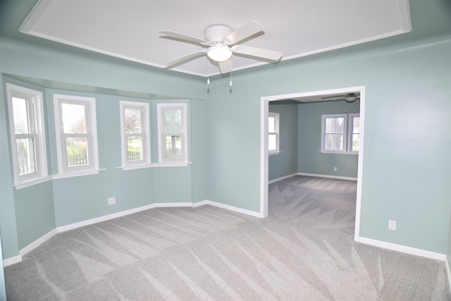 carpeted spare room with ceiling fan