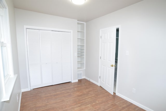 unfurnished bedroom with hardwood / wood-style flooring