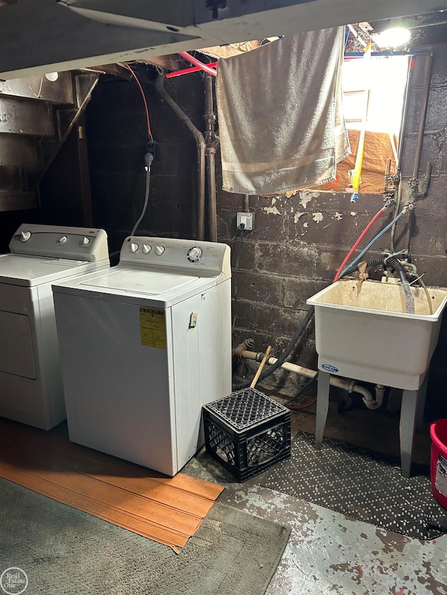 clothes washing area featuring washer and clothes dryer and sink