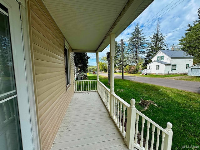 deck with a yard and covered porch