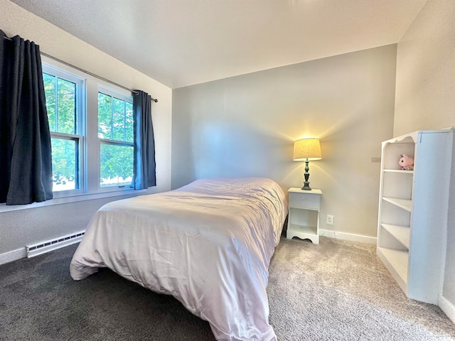 bedroom with baseboard heating and carpet