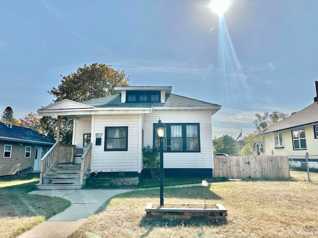 bungalow-style home featuring a front yard