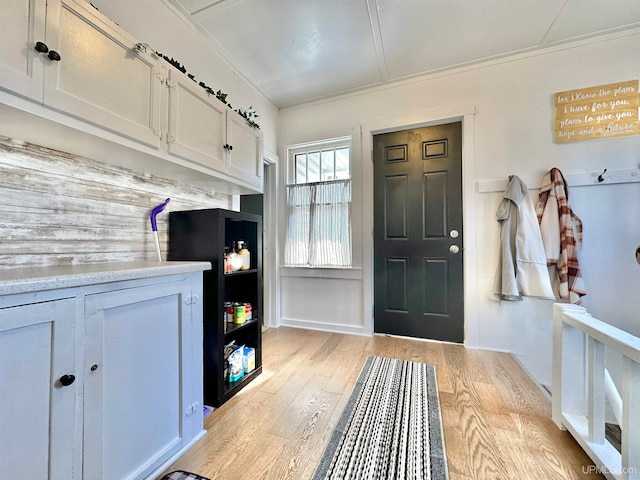 mudroom featuring crown molding and light hardwood / wood-style flooring