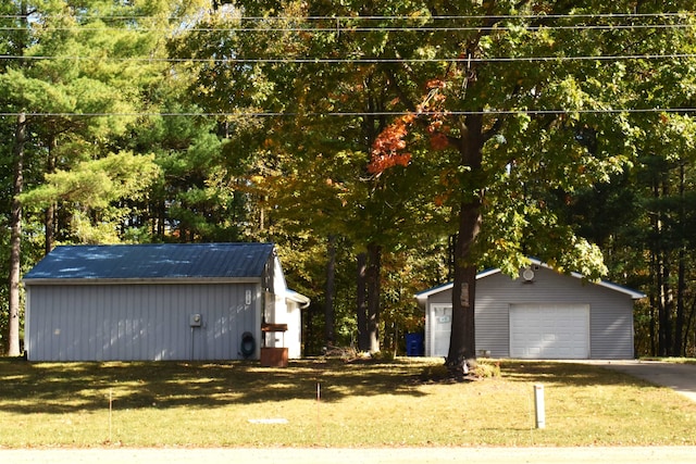 exterior space with a garage and a lawn