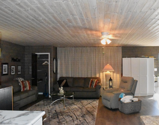 living room with wood ceiling and ceiling fan