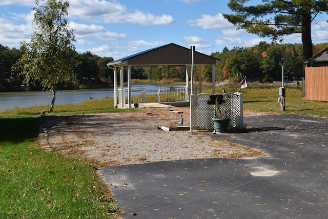 view of yard with a water view and a carport