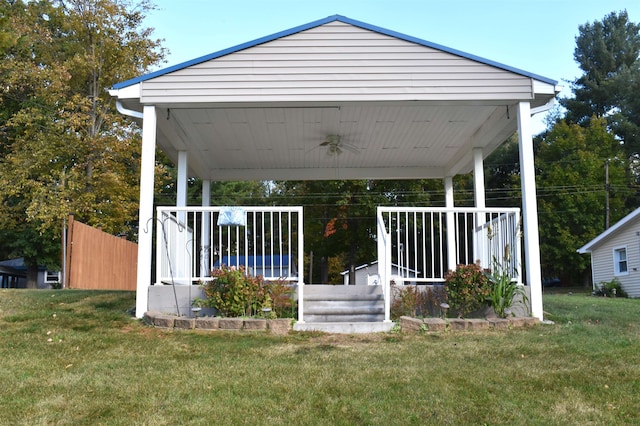 exterior space featuring a porch, ceiling fan, and a lawn