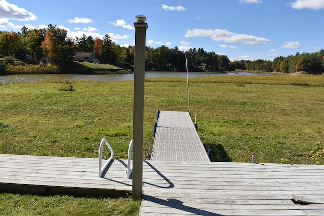 dock area with a water view and a yard