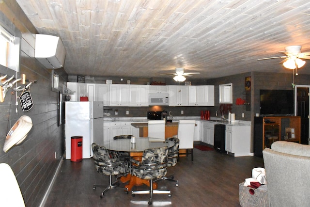 dining space with ceiling fan, sink, and dark hardwood / wood-style flooring