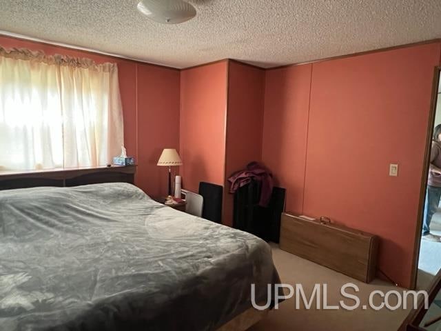 bedroom with carpet flooring and a textured ceiling