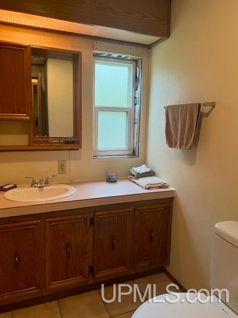 bathroom with tile patterned floors, vanity, and toilet