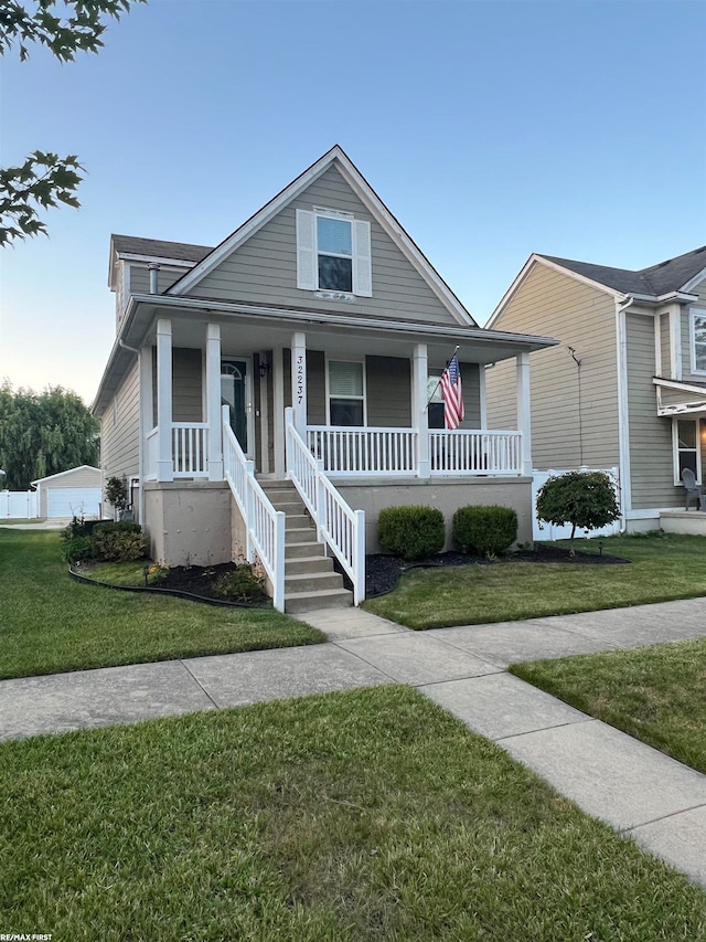 view of front of property with covered porch and a front yard