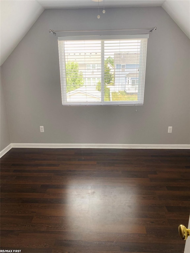 bonus room featuring dark wood-type flooring and vaulted ceiling