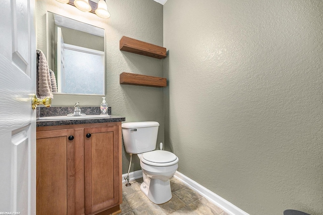 bathroom featuring toilet and vanity