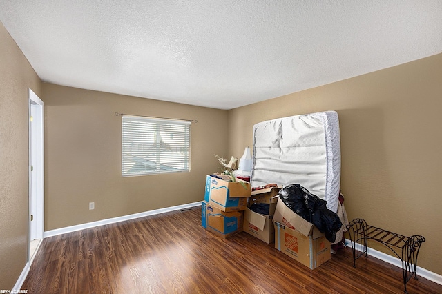 misc room featuring a textured ceiling and dark hardwood / wood-style floors