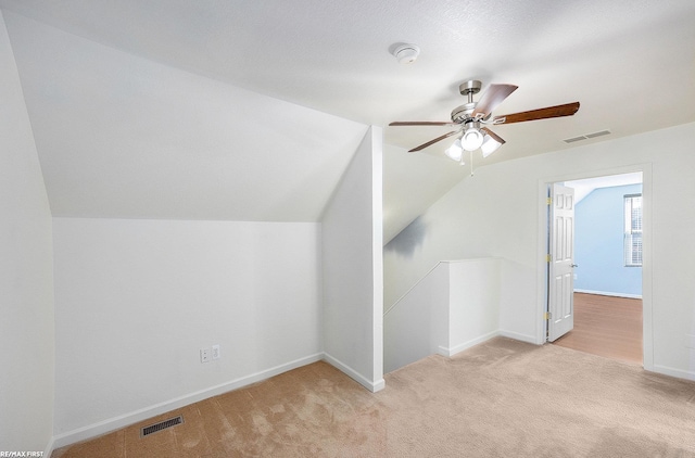 bonus room featuring ceiling fan, lofted ceiling, and light colored carpet