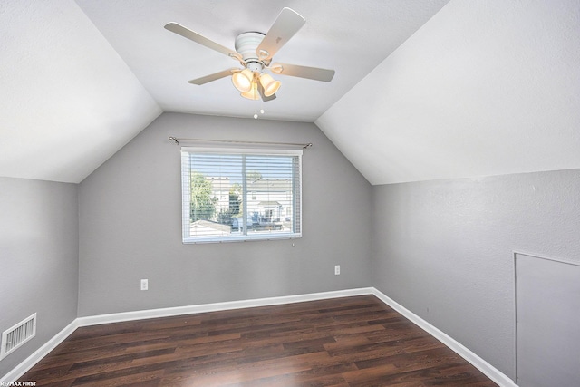 additional living space featuring vaulted ceiling, dark hardwood / wood-style floors, and ceiling fan