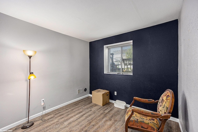 sitting room with hardwood / wood-style floors