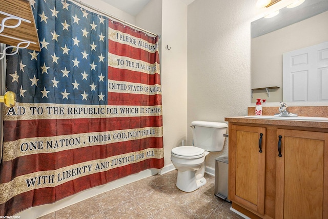 bathroom featuring vanity, toilet, tile patterned floors, and walk in shower