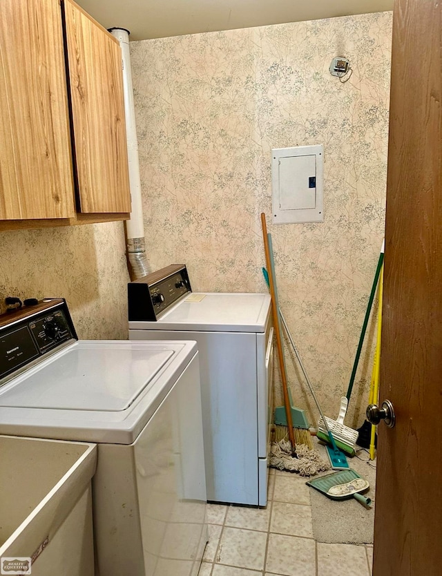 laundry area with washer and dryer, electric panel, cabinets, and light tile patterned floors