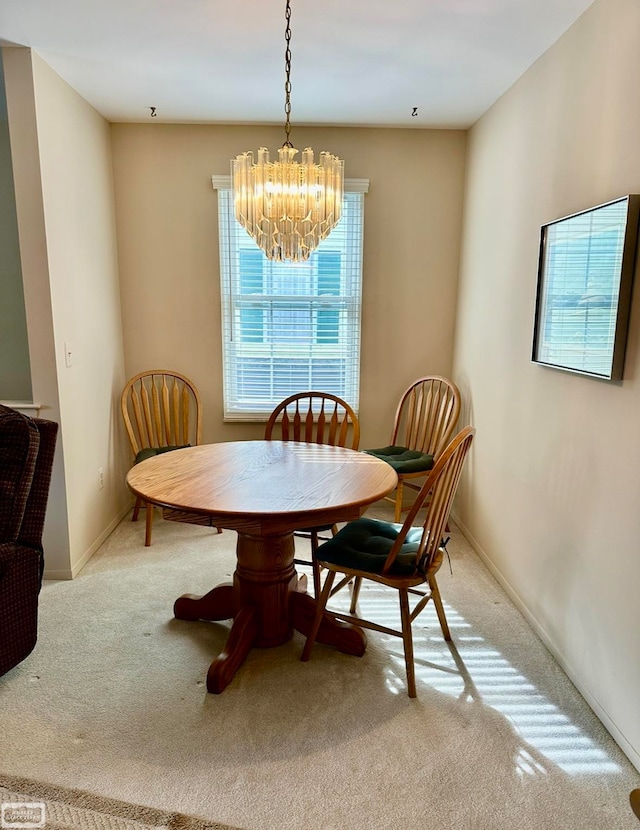 dining room with a notable chandelier and light colored carpet