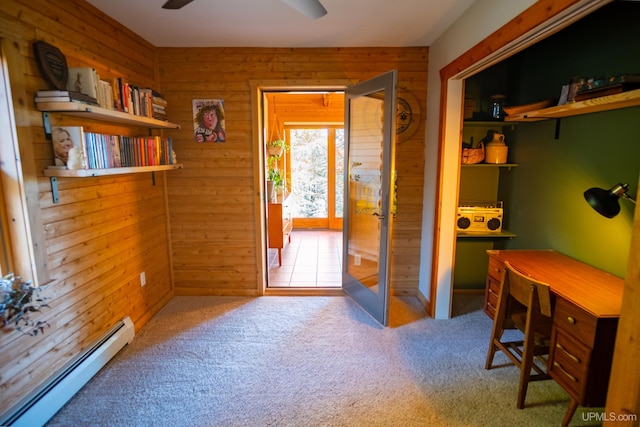 office with carpet floors, wood walls, and a baseboard heating unit