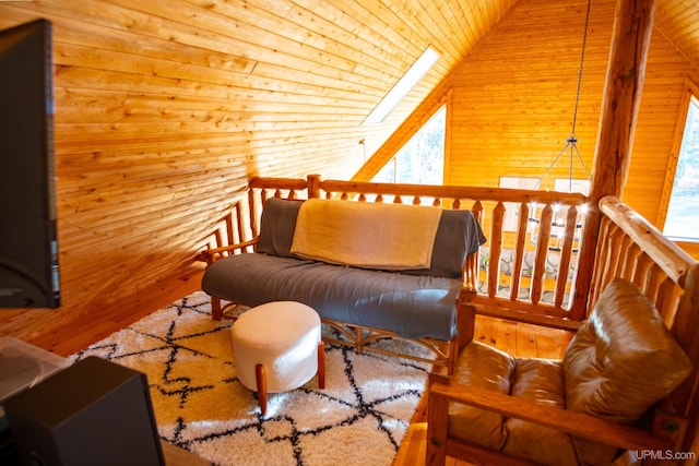 living room with vaulted ceiling with skylight, wooden ceiling, hardwood / wood-style flooring, and wooden walls