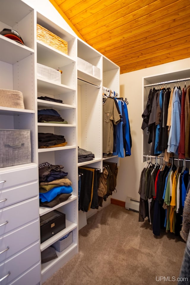 walk in closet with a baseboard radiator and carpet