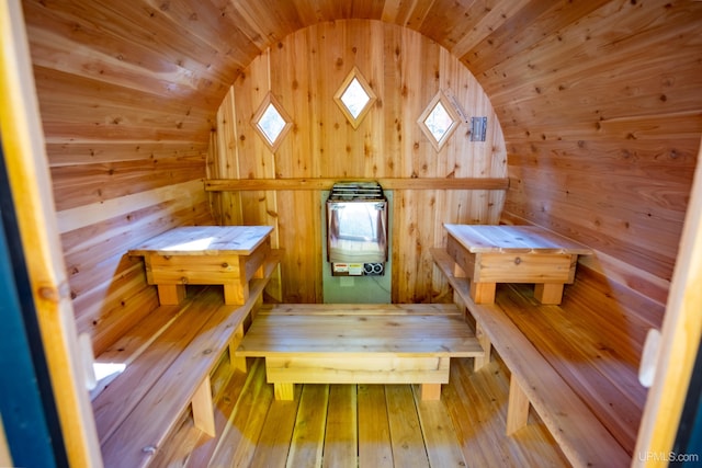 view of sauna featuring a skylight, wood walls, wood ceiling, and wood-type flooring