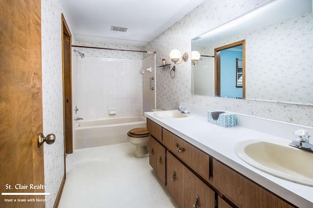 full bathroom with vanity, toilet, and tiled shower / bath